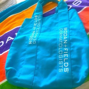 Rodan + Fields Blue Canvas bag and striped beach towel